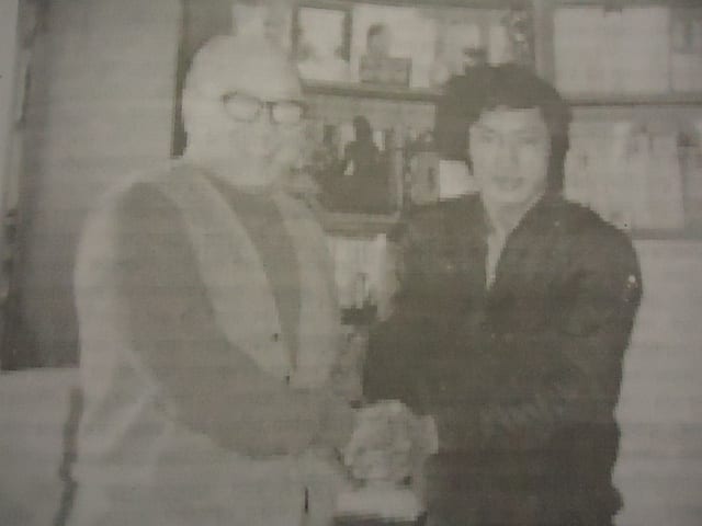 Black and white archival photograph taken indoors at an early Association event.